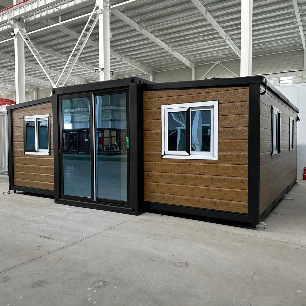 Wood-look expandable home with dark framing, a glazed entrance and windows on the front and side.