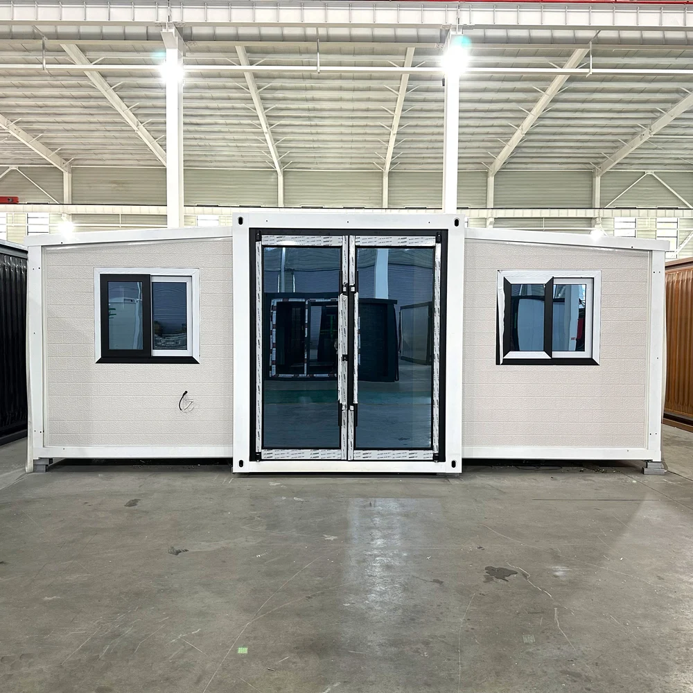 White exterior — front view White front elevation with a tall central glazed entrance and two dark-framed windows.