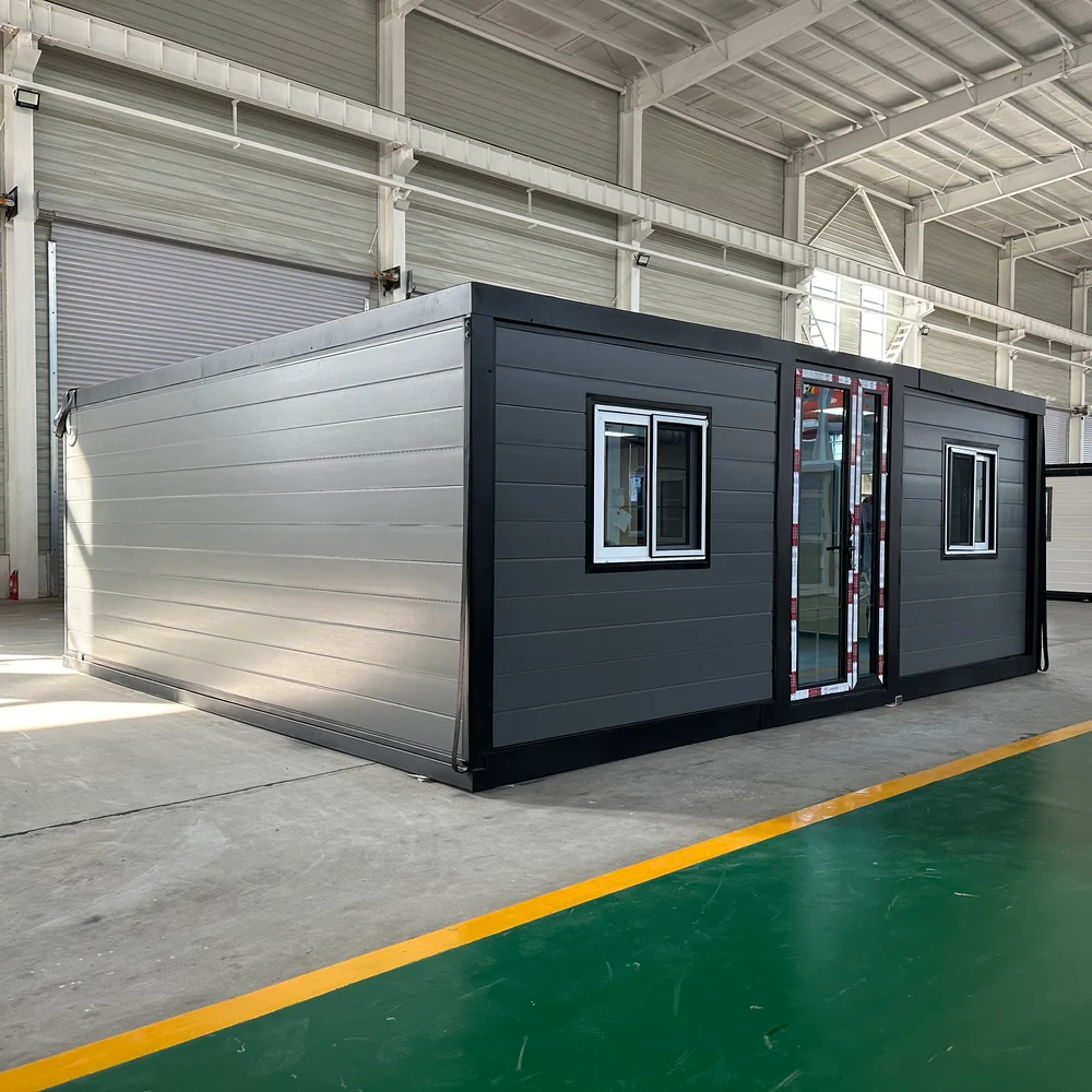 Qinbo Modern 20 — Grey Exterior — Central Entrance, Angle Grey expandable home viewed from a corner, with a central glazed entrance and a window on either side.