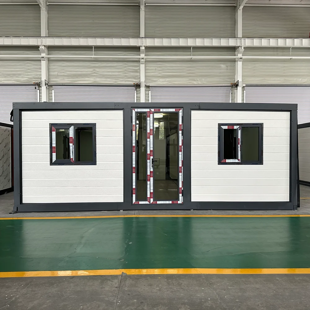 Qinbo Modern 20 — White Exterior — Central Entrance White expandable home with dark framing, a central glazed entrance and two front windows.