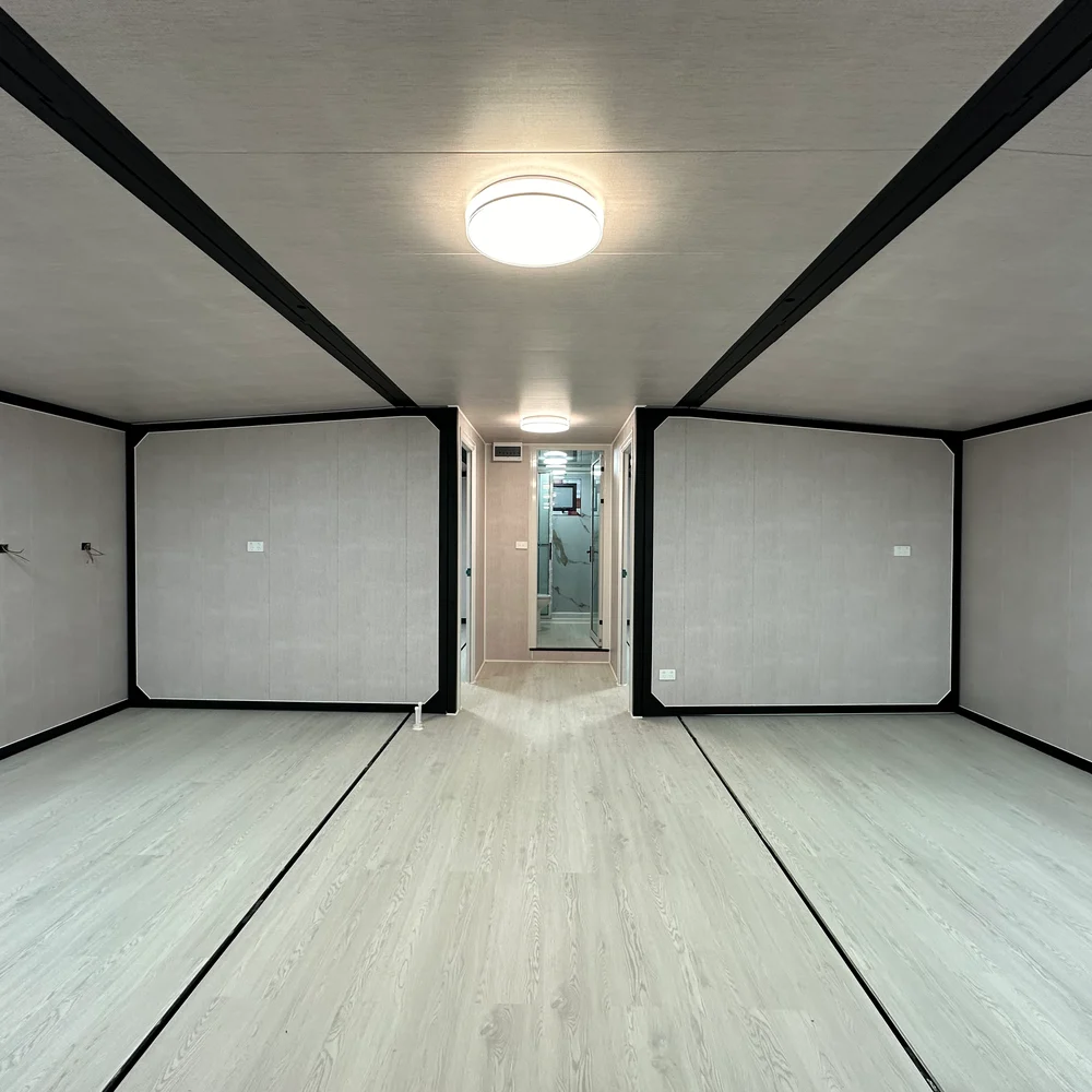 Open interior — central passage Unfurnished interior with dark framing and a central passage between two partitioned areas.