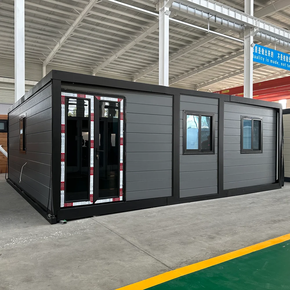 Qinbo Modern 20 — Grey Exterior — Offset Entrance, Angle Grey expandable home with an offset glazed entrance, two front windows and a visible side wall.
