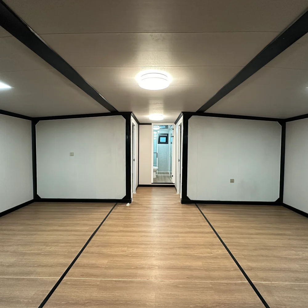 Open interior — central passage Unfurnished interior with brown wood-look flooring and a central passage between partitions.