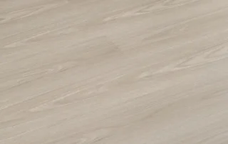 Light oak-effect SPC flooring sample with visible plank joints.