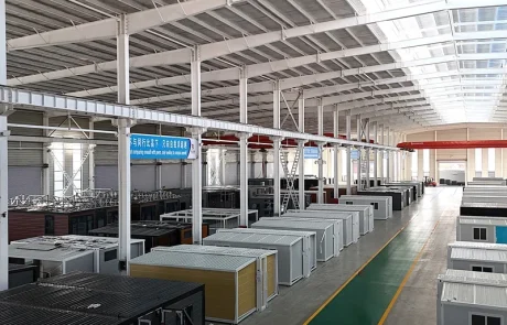 04-qinbo-factory-assembly-area Rows of partly assembled expandable homes inside the factory, viewed from above.
