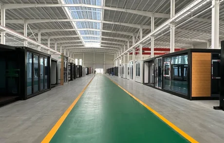 05-qinbo-factory-completed-home-aisle Rows of completed expandable homes with glazed fronts inside the factory.