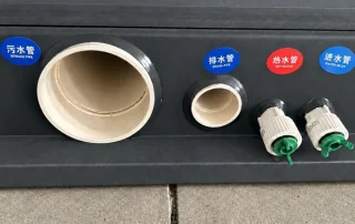 Exterior waste, drainage, hot-water and water-inlet connections.