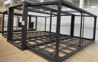 Complete expanded steel frame with exposed main and wing floor-support grids.