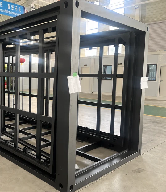 Close view of coated steel columns and cross-members in a folded house frame.