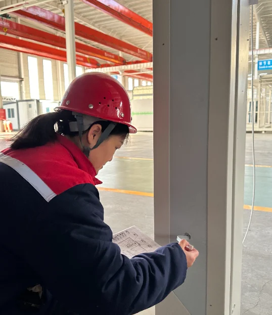 Inspector checking wiring beside an interior wall panel.