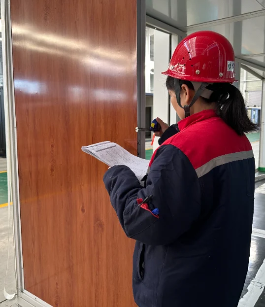 Inspector checking exterior wall panels against a list.