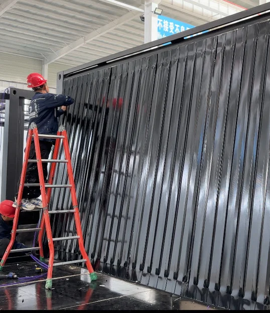 Workers on a ladder checking corrugated metal roof sheeting while the wing is upright.