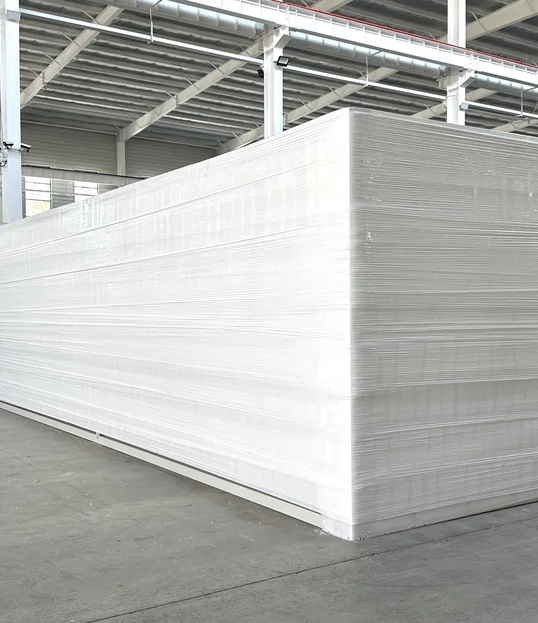 Folded expandable home protected with white wrap for shipment.